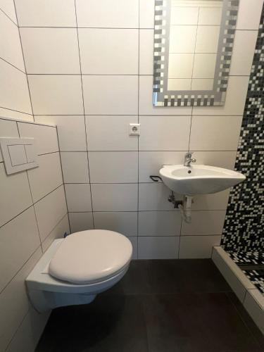 a bathroom with a toilet and a sink at Maison in Dudelange