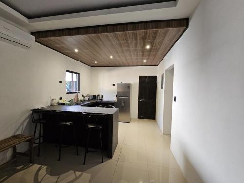 a kitchen with a island in the middle of a room at CASA TRES RIOS EN OSA in Coronado