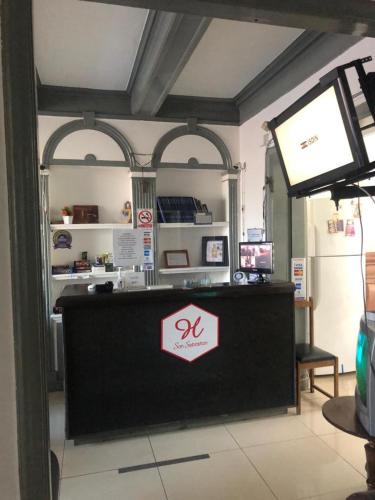 a shop with a counter with a sign on it at San Sebastian in Concepción