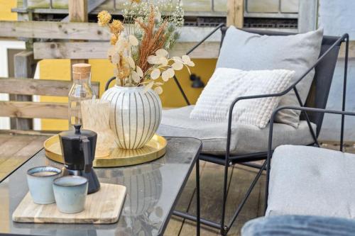 a glass table with a vase on top of it at City center apartment w/ large private balcony in Aalborg