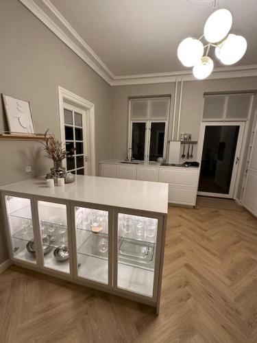 a living room with a counter and a kitchen at City center apartment w/ large private balcony in Aalborg