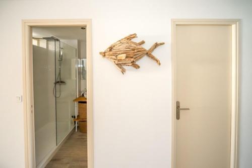 a bathroom with a walk in shower next to a door at T3 Octopus Vue Mer Palavas Parking in Palavas-les-Flots