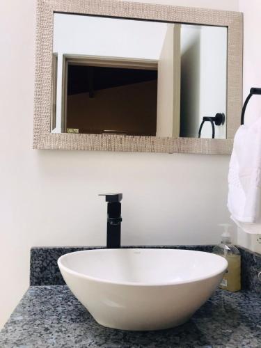 a white bowl sink on a counter in a bathroom at Hotel & Golf Isak Aeropuerto in Rionegro