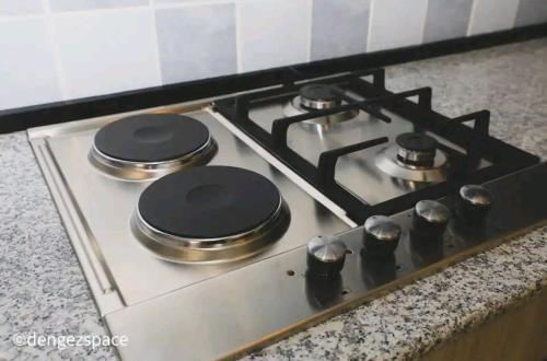 a stove top with two burners on it in a kitchen at Royal Milk pipeline apartment in Addis Ababa