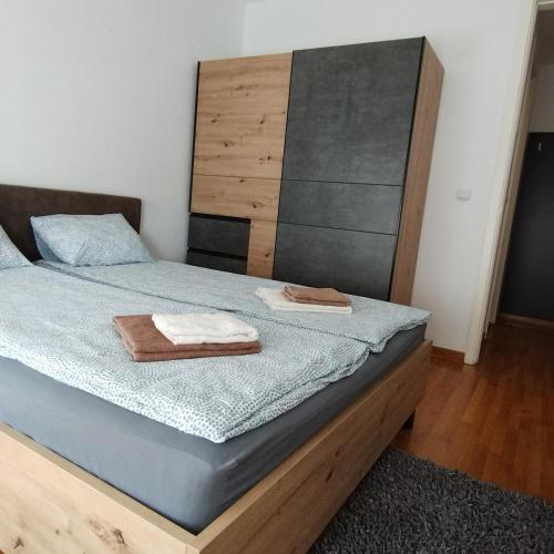 a bedroom with a bed with two towels on it at Apartment Belville, Suncokret 34 in Novi Beograd