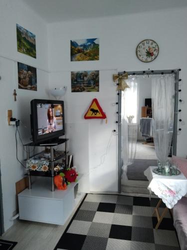 a living room with a tv on a white wall at Byt 2kk v Liberci in Liberec