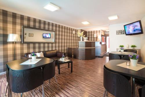 a restaurant with couches and tables in a room at Green Hostel in Toruń