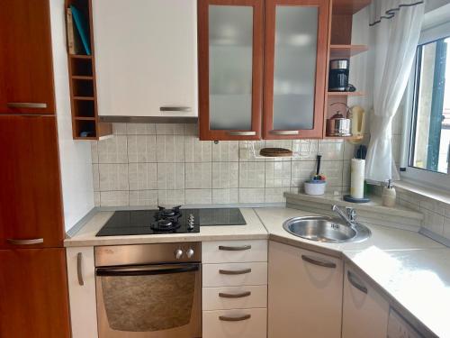 a small kitchen with a sink and a stove at Apartment Simon in Bol