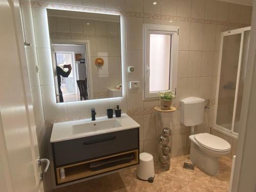 a bathroom with a sink and a toilet and a mirror at Apartment Simon - Old Stone Charm, Central Bol Life in Bol