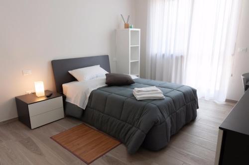 a small bedroom with a bed and a night stand at Novatek Apartment B&B in Chieti