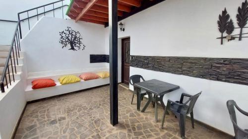 a room with a table and chairs and a table and a bench at Lanzarote Hostel in Arrecife