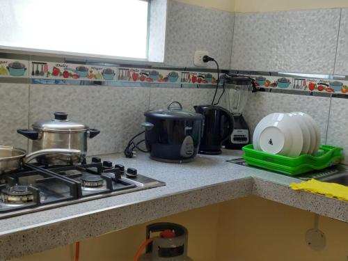 a kitchen counter top with a stove and a sink at LA CASA DE LA ABUELA in Barranca
