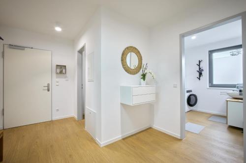 a white room with a sink and a mirror at Ferienwohnung Schwarmstedt in Schwarmstedt