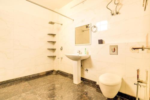 a bathroom with a sink and a toilet at House of Comfort Noida in Noida