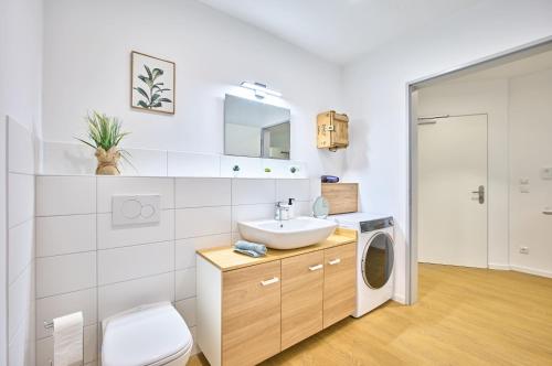 a bathroom with a sink and a washing machine at Ferienwohnung Schwarmstedt in Schwarmstedt