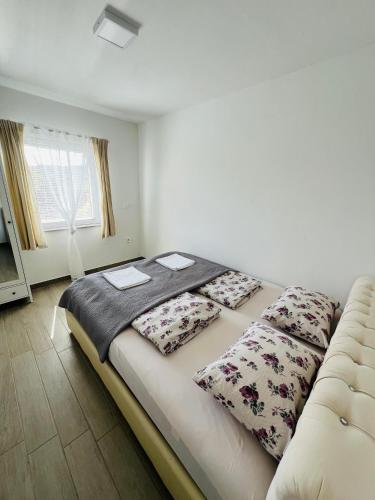 a bed with two pillows on it in a room at Apartments Jagodje in Izola