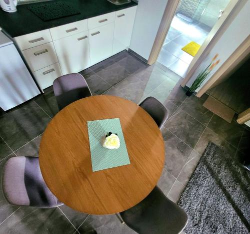 a wooden table and chairs in a kitchen at Apartman Mate in Rakovica