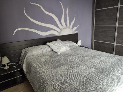 a bedroom with a bed with a painting on the wall at Reus Mediterrani in Cambrils