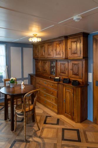 a kitchen with wooden cabinets and a wooden table at Peterhof Sarnen in Sarnen