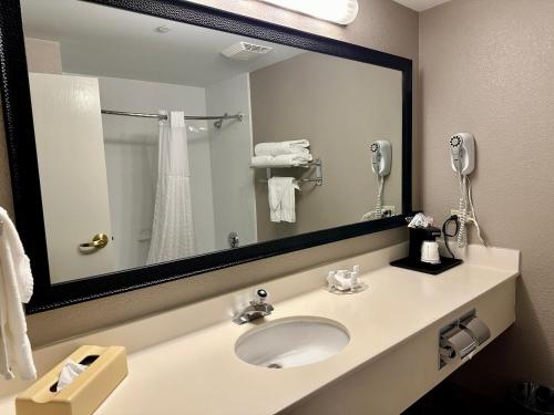 a bathroom with a sink and a large mirror at La Quinta by Wyndham Bannockburn-Deerfield in Bannockburn