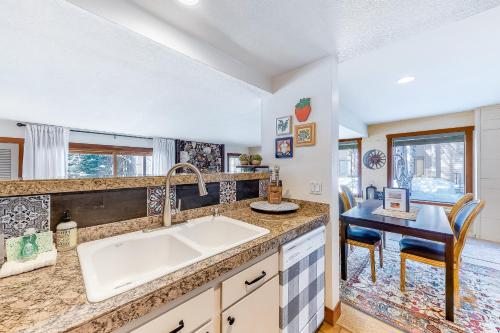 a kitchen with a sink and a table with chairs at Snowcreek 1536 in Sun Valley