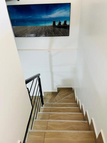 a picture hanging on a wall above a stairway at Cozy one bedroom duplex apartment in kinoo in Nairobi