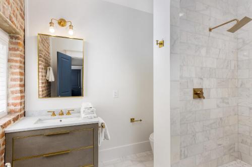 a bathroom with a sink and a shower at State St A by AvantStay Heart of French Quarter in Charleston