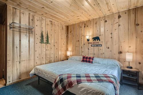 a bedroom with a bed in a wooden wall at Lift Landing in Idaho Springs
