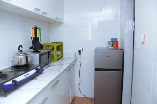 a kitchen with a stove and a refrigerator at Festac in Lagos