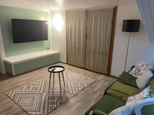 a living room with a couch and a table at B&B Villa Alma in San Costanzo