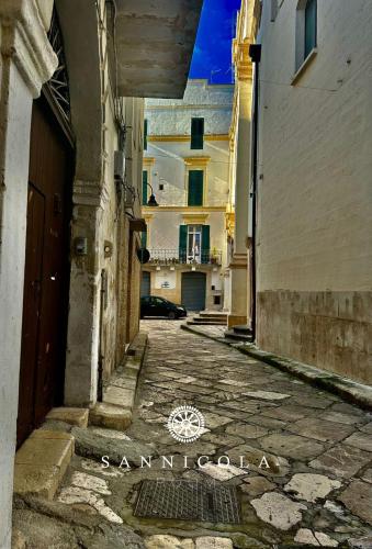 an empty alley with a building in the background at San Nicola Room e spa in Gravina in Puglia