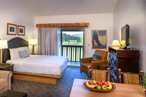 a hotel room with a bed and a balcony at Stoneridge Resort in Blanchard