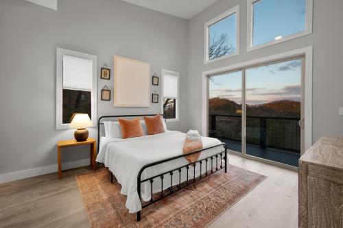1 dormitorio con cama y ventana grande en Mountain View Manor Pool Hot Tub Game Room, en Sevierville