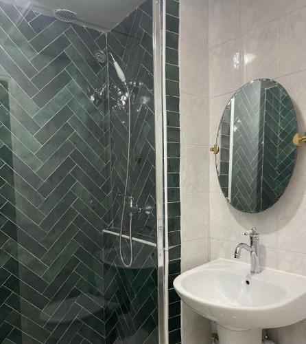 une salle de bain avec un lavabo et une douche avec un miroir dans l'établissement Magnifique Suite - Centre ville, à Marseille