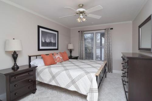 a bedroom with a bed and a ceiling fan at Southern Comfort Cabin in Lake Murray Shores