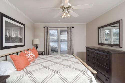 a bedroom with a bed and a ceiling fan at Southern Comfort Cabin in Lake Murray Shores
