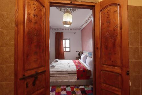 a door leading to a bedroom with a bed at View Peaks Lodge in Imlil