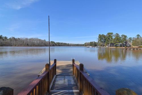 a dock with a fishing pole on the water at Southern Comfort Cabin in Lake Murray Shores