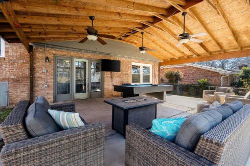 a patio with two couches and a ping pong table at Spacious Oasis With Pool - 5BR in Columbia