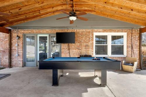 a pool table in front of a house with a ceiling fan at Spacious Oasis With Pool - 5BR in Columbia