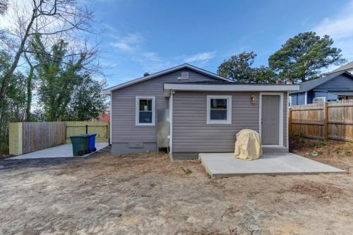a tiny house in a yard with a fence at Stadium View Stay - Rosewood in Columbia