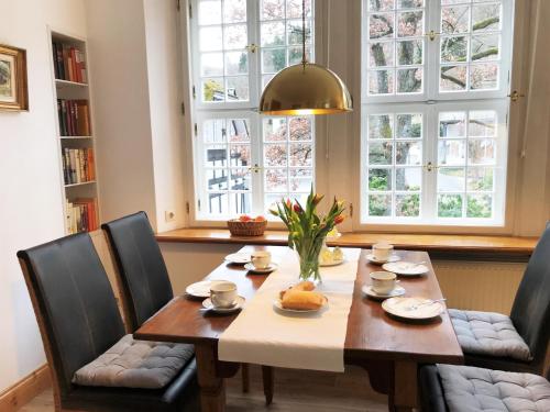a dining room with a table and chairs and windows at Welcome Home in Winterberg