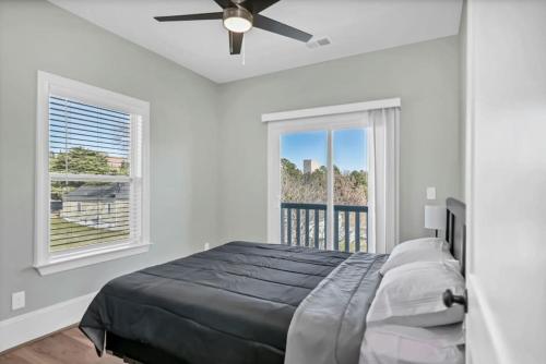 a bedroom with a bed and a ceiling fan at The Graveyard - Downtown in Columbia