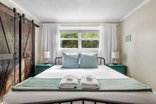 a bedroom with a bed with two towels on it at Vintage Sunrise Home-Lake View in Lake Murray Shores