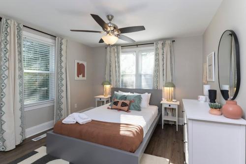 a bedroom with a bed and a ceiling fan at Forest Acres Boho Home - 2BR in Columbia
