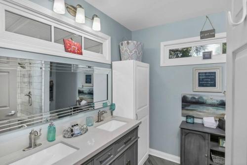 a bathroom with two sinks and a mirror at 2BR Cottage - Minutes from USC in Columbia