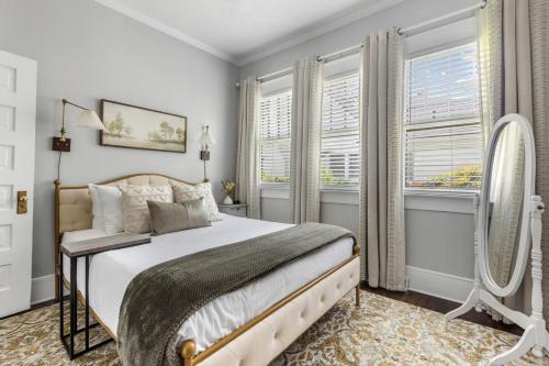 a bedroom with a large bed and two windows at Cottontown 3BR - Mins to USC in Columbia