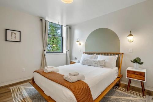 a bedroom with a large bed with towels on it at Alchemist - The Vestry on Read in Columbia