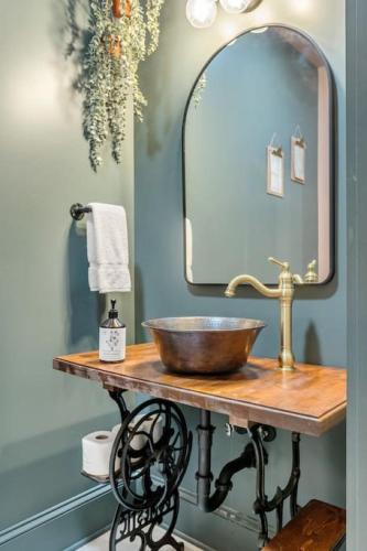 a bathroom with a sink and a mirror at Carraway - The Vestry on Read in Columbia