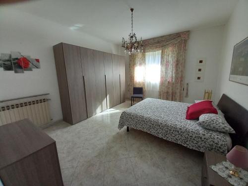 a bedroom with a bed and a dresser and a window at la casa di sotto in Alpignano